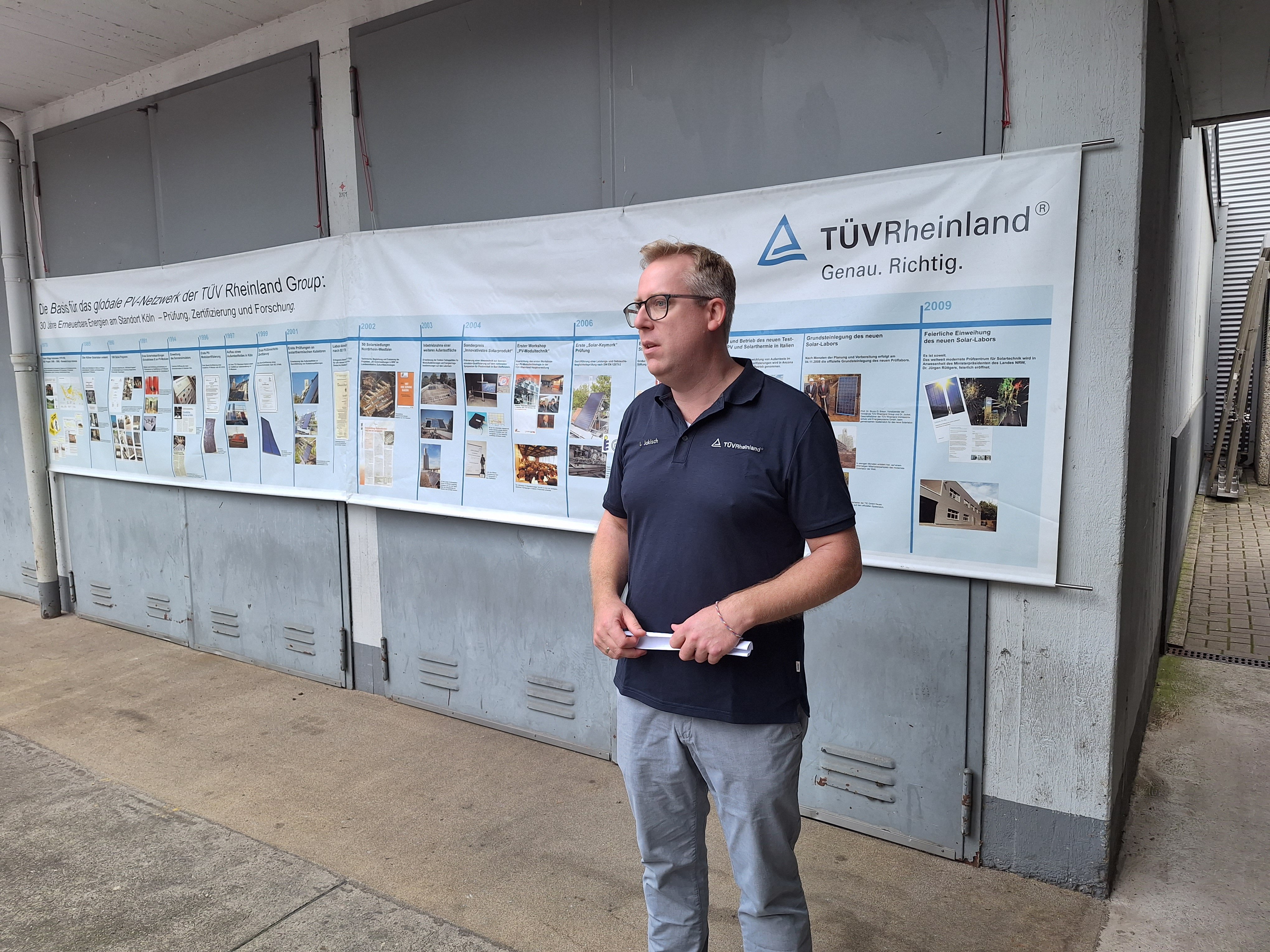 Man in front of poster of timeline